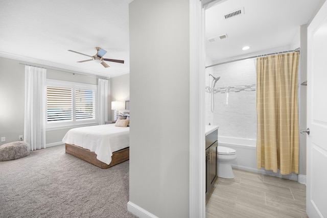 bedroom with baseboards, ensuite bathroom, ornamental molding, and visible vents