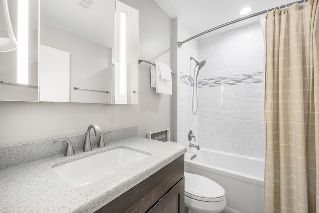 bathroom featuring visible vents, shower / bathtub combination with curtain, toilet, and vanity