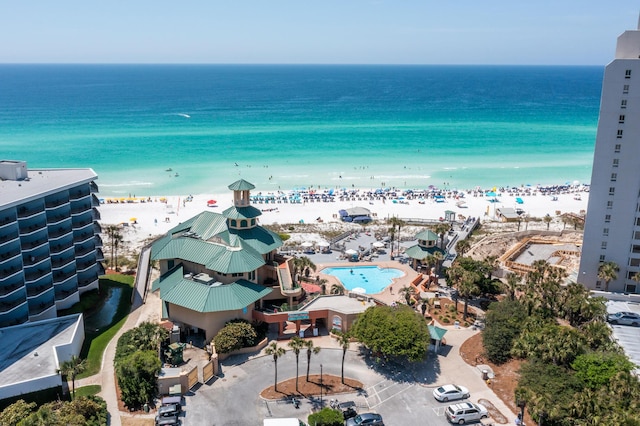 drone / aerial view with a water view and a beach view