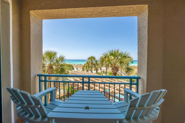 balcony with a water view and a beach view