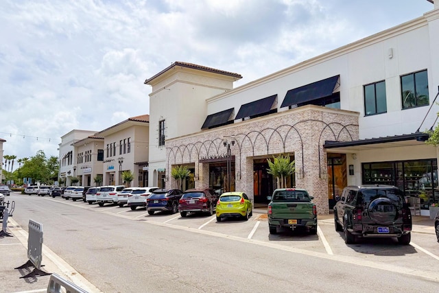 view of building exterior with uncovered parking