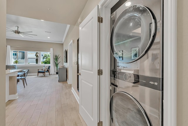 732 Scenic Gulf Dr Unit D103, Miramar Beach, FL 32550 - clothes washing area featuring laundry area, ornamental molding, stacked washing maching and dryer, baseboards, and light wood-style floors