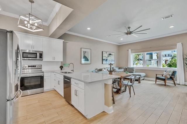 732 Scenic Gulf Dr Unit D103, Miramar Beach, FL 32550 - kitchen with a sink, a peninsula, crown molding, open floor plan, and appliances with stainless steel finishes