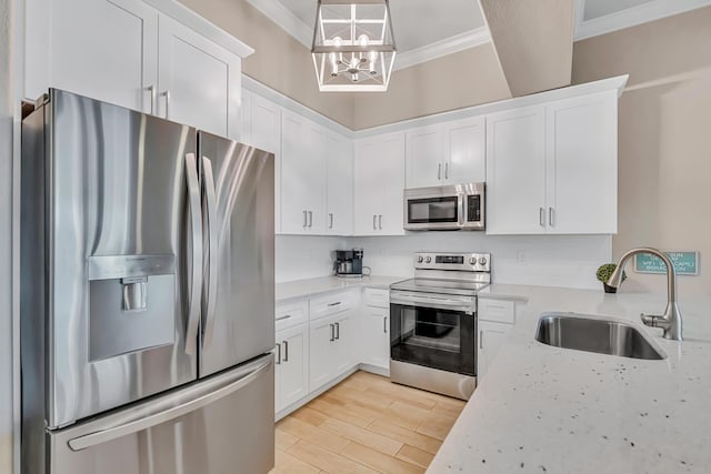 732 Scenic Gulf Dr Unit D103, Miramar Beach, FL 32550 - kitchen featuring a sink, ornamental molding, stainless steel appliances, and white cabinets