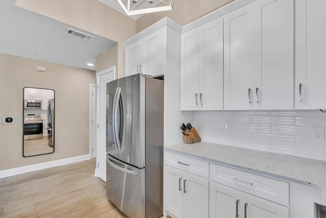 732 Scenic Gulf Dr Unit D103, Miramar Beach, FL 32550 - kitchen with light stone countertops, tasteful backsplash, visible vents, stainless steel appliances, and white cabinets