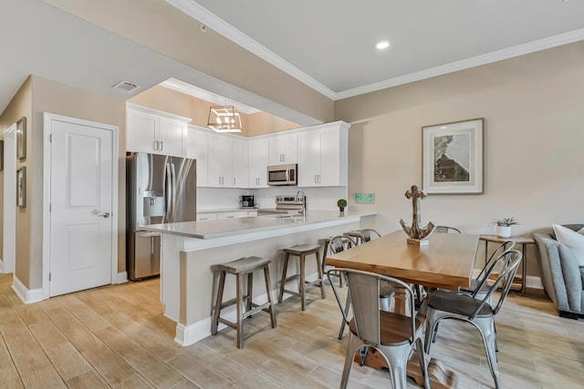 732 Scenic Gulf Dr Unit D103, Miramar Beach, FL 32550 - kitchen featuring stainless steel appliances, visible vents, white cabinetry, a peninsula, and light countertops