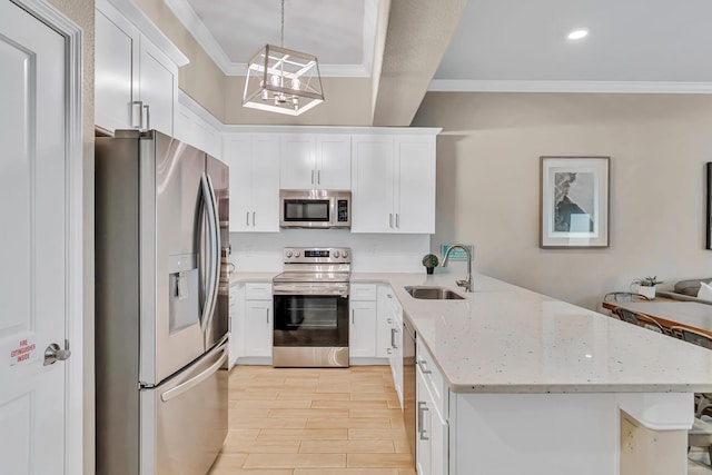 732 Scenic Gulf Dr Unit D103, Miramar Beach, FL 32550 - kitchen featuring ornamental molding, a sink, a peninsula, white cabinets, and appliances with stainless steel finishes