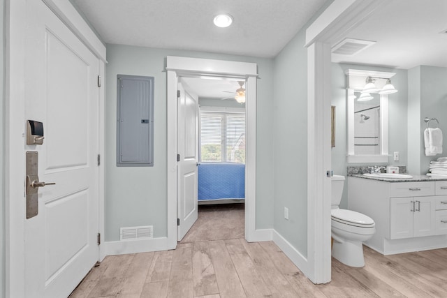 11807 Front Beach Rd # 1-309, Panama City Beach, FL 32407 - full bathroom with wood finished floors, visible vents, toilet, and electric panel