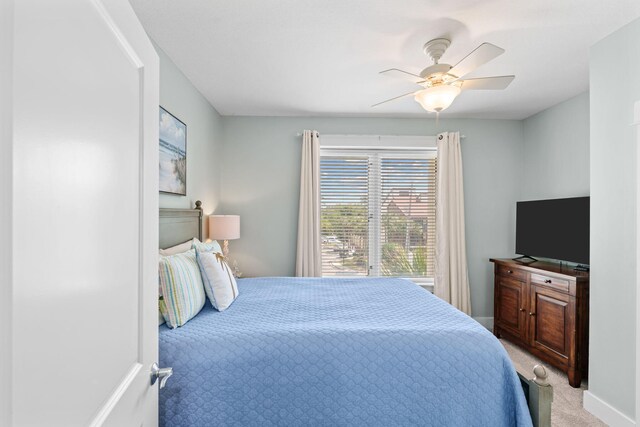 11807 Front Beach Rd # 1-309, Panama City Beach, FL 32407 - bedroom with baseboards, a ceiling fan, and light colored carpet