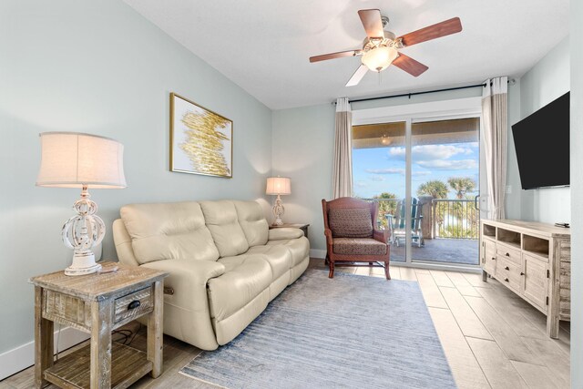 11807 Front Beach Rd # 1-309, Panama City Beach, FL 32407 - living room featuring baseboards, ceiling fan, and light wood-style flooring