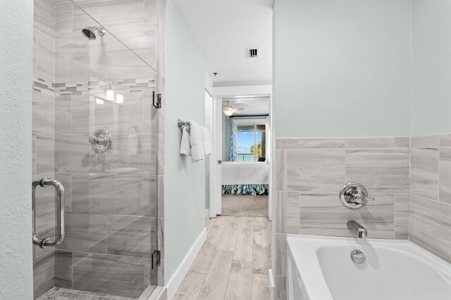 11807 Front Beach Rd # 1-309, Panama City Beach, FL 32407 - ensuite bathroom with visible vents, a stall shower, and a tub