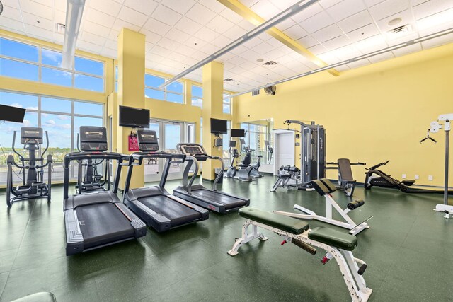 11807 Front Beach Rd # 1-309, Panama City Beach, FL 32407 - workout area featuring a towering ceiling, a paneled ceiling, visible vents, and a healthy amount of sunlight