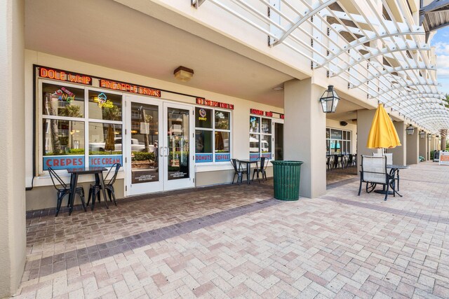 11807 Front Beach Rd # 1-309, Panama City Beach, FL 32407 - view of patio / terrace with a pergola, outdoor dining space, and french doors