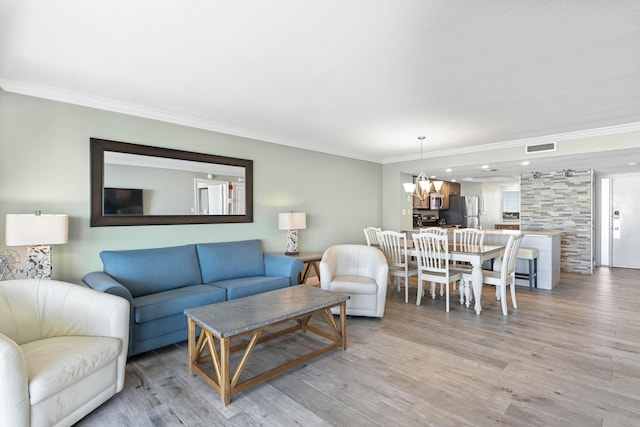 291 Scenic Gulf Dr Unit 900, Miramar Beach, FL 32550 - living area with crown molding, a chandelier, and light wood-style flooring