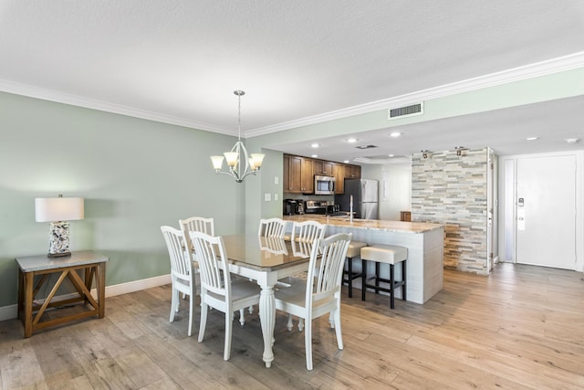 291 Scenic Gulf Dr Unit 900, Miramar Beach, FL 32550 - dining space featuring ornamental molding, light wood-style floors, a chandelier, recessed lighting, and baseboards