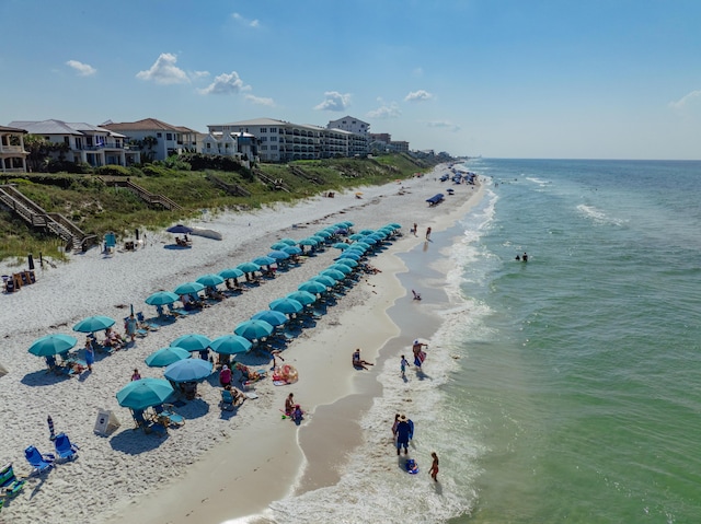 drone / aerial view with a beach view and a water view