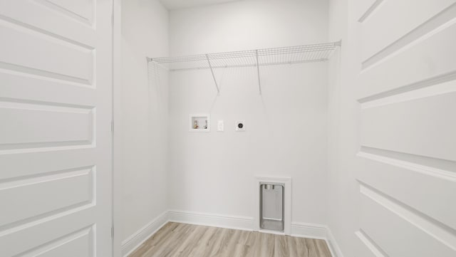 laundry room with light wood finished floors, hookup for an electric dryer, baseboards, hookup for a washing machine, and laundry area