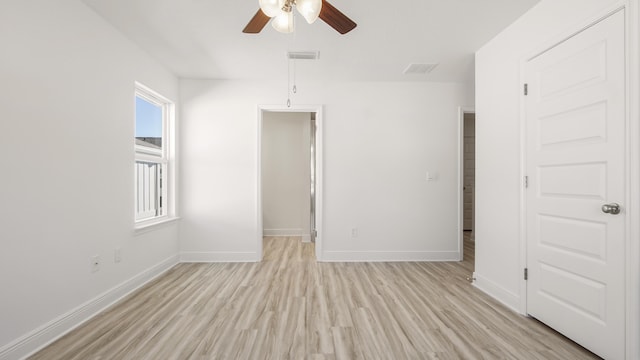 spare room with visible vents, baseboards, light wood-style floors, and ceiling fan