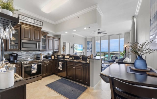 1517 Miracle Strip Pkwy Unit Ph01, Fort Walton Beach, FL 32548 - kitchen featuring dark countertops, tasteful backsplash, dark brown cabinets, and stainless steel appliances