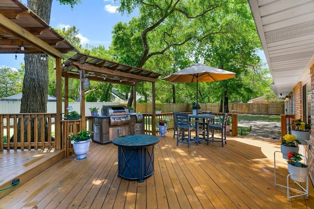 wooden deck with a fenced backyard, outdoor dining area, and area for grilling
