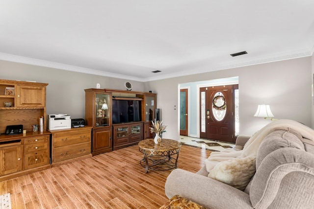 living area featuring ornamental molding and light wood finished floors