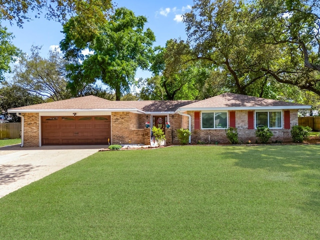 ranch-style house featuring an attached garage, driveway, and brick siding