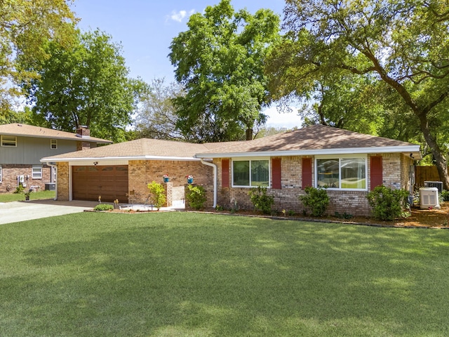 ranch-style house featuring brick siding, a garage, a front lawn, concrete driveway, and cooling unit