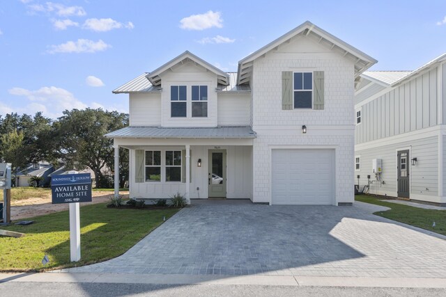 9620 Indian Stone Ct Lot 7, Navarre, FL 32566 - modern farmhouse style home featuring an attached garage, driveway, a front yard, and metal roof