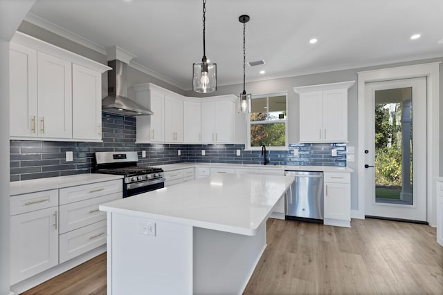 9620 Indian Stone Ct Lot 7, Navarre, FL 32566 - kitchen with wall chimney exhaust hood, a wealth of natural light, appliances with stainless steel finishes, and crown molding