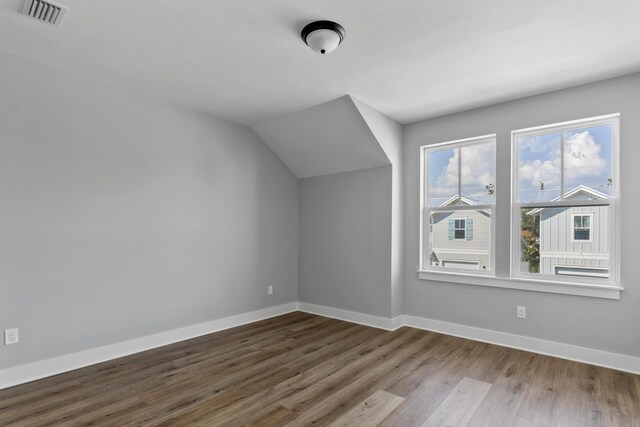 9620 Indian Stone Ct Lot 7, Navarre, FL 32566 - bonus room with vaulted ceiling, wood finished floors, visible vents, and baseboards