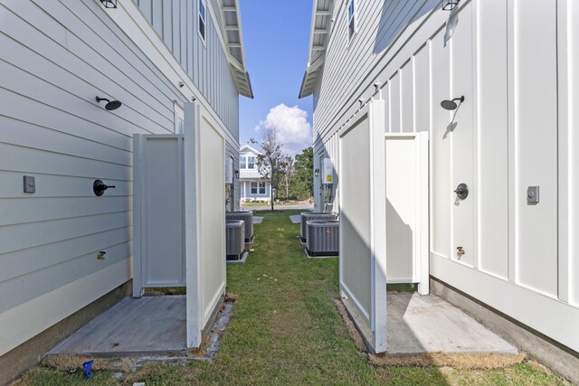 9620 Indian Stone Ct Lot 7, Navarre, FL 32566 - view of property exterior with cooling unit, a yard, and board and batten siding