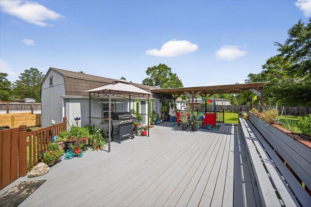 1192 Oakwood Lakes Blvd, Defuniak Springs, FL 32433 - deck with a fenced backyard and grilling area
