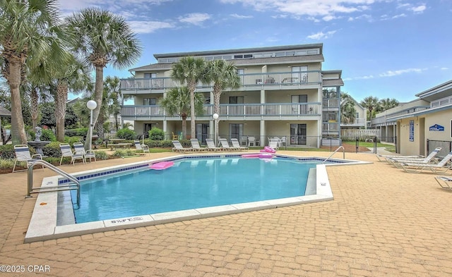 community pool featuring a patio and fence