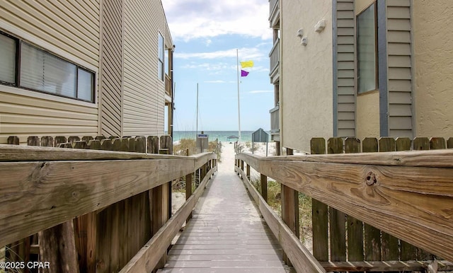view of property exterior featuring a beach view and a water view