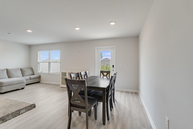 dining room featuring light wood-style floors, recessed lighting, and baseboards