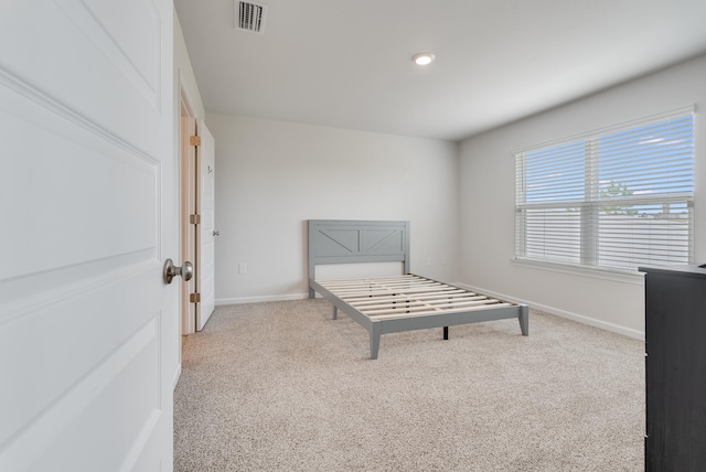 unfurnished bedroom with baseboards, visible vents, and carpet flooring