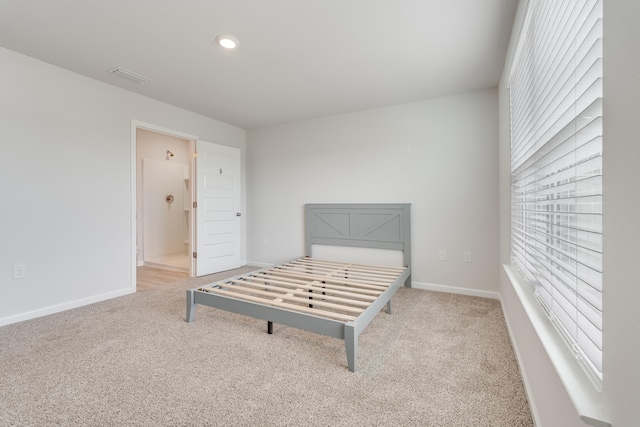 unfurnished bedroom featuring recessed lighting, ensuite bath, carpet, baseboards, and visible vents