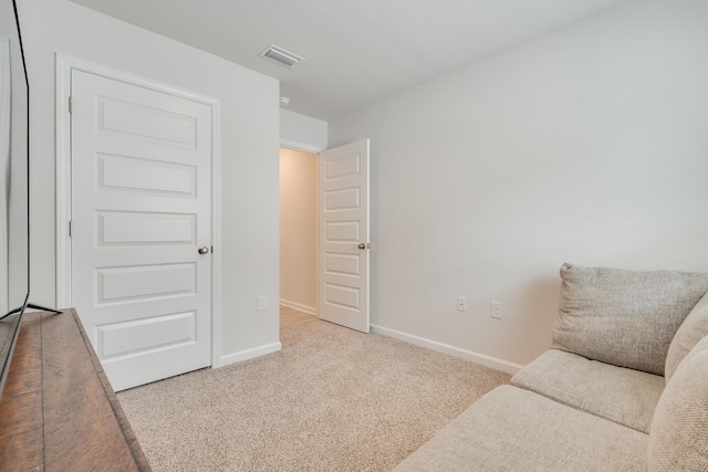sitting room featuring baseboards, visible vents, and carpet floors