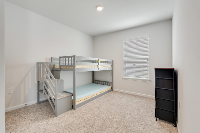 unfurnished bedroom with baseboards and carpet flooring