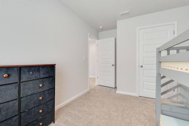 unfurnished bedroom with baseboards, visible vents, and carpet floors