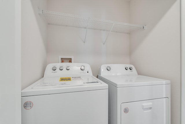 laundry room featuring washing machine and dryer and laundry area