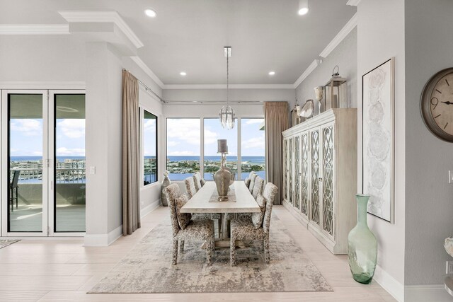320 Harbor Blvd Unit 1201, Destin, FL 32541 - dining area with a water view, ornamental molding, baseboards, and a notable chandelier