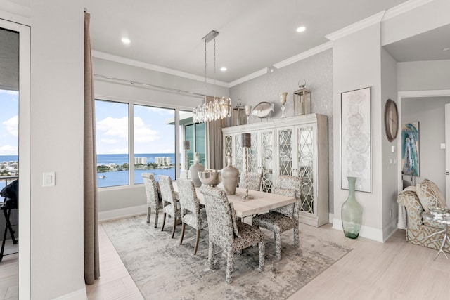 320 Harbor Blvd Unit 1201, Destin, FL 32541 - dining room with baseboards, ornamental molding, a water view, and a notable chandelier