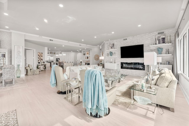 320 Harbor Blvd Unit 1201, Destin, FL 32541 - living area featuring crown molding, a fireplace, recessed lighting, light wood-type flooring, and visible vents
