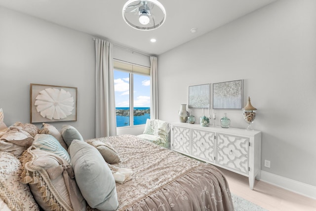 320 Harbor Blvd Unit 1201, Destin, FL 32541 - bedroom with a water view, baseboards, recessed lighting, and light wood-style floors