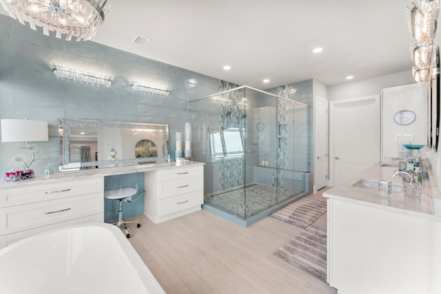320 Harbor Blvd Unit 1201, Destin, FL 32541 - full bath featuring visible vents, a shower stall, wood finished floors, vanity, and a soaking tub