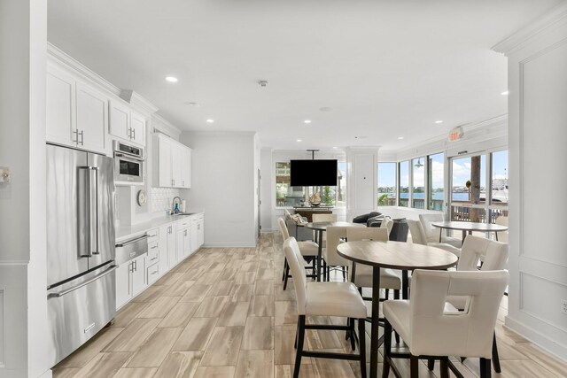 320 Harbor Blvd Unit 1201, Destin, FL 32541 - kitchen with a sink, high end refrigerator, white cabinetry, recessed lighting, and tasteful backsplash