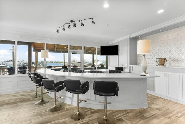 320 Harbor Blvd Unit 1201, Destin, FL 32541 - kitchen featuring light countertops, recessed lighting, ornamental molding, and a kitchen bar