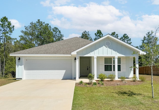 58 Eunola Ln, Freeport, FL 32439 - single story home featuring board and batten siding, concrete driveway, roof with shingles, an attached garage, and a front lawn