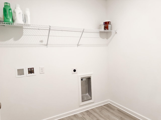 58 Eunola Ln, Freeport, FL 32439 - washroom with hookup for an electric dryer, baseboards, hookup for a washing machine, wood finished floors, and laundry area